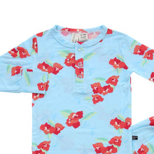 Load image into Gallery viewer, A two-piece toddler pajama set with a sky blue background and red floral print. The set includes a long-sleeve top and matching pants with a snap closure at the neckline.