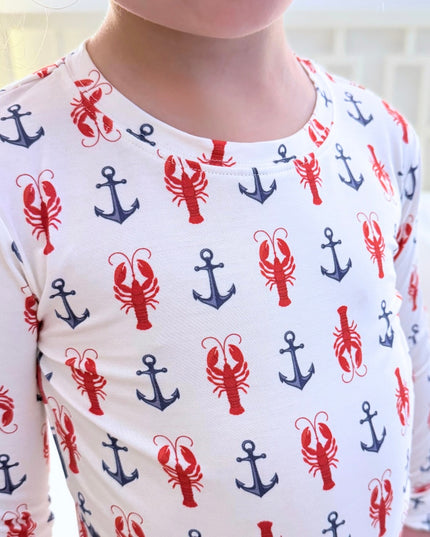 Long-sleeve shirt with red and blue anchor and lobster pattern on a white background