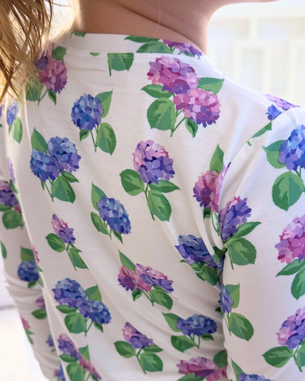 White shirt with purple and blue floral pattern on the back.