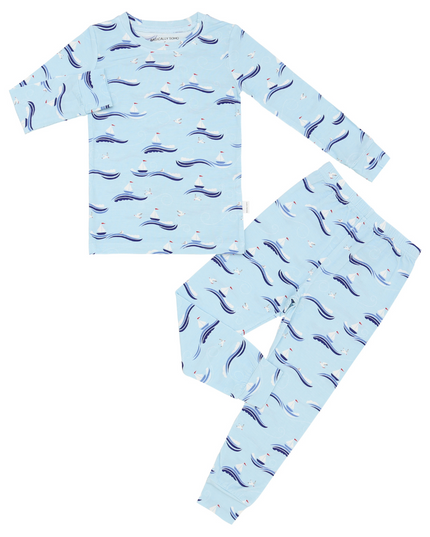 A two-piece toddler pajama set with a pale blue background featuring a repeating pattern of sailboats and seagulls.