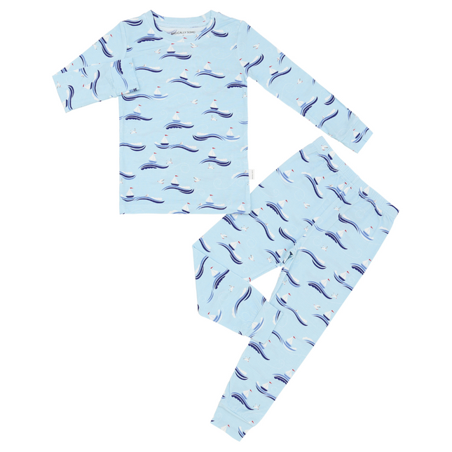 A two-piece toddler pajama set with a pale blue background featuring a repeating pattern of sailboats and seagulls.